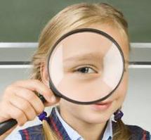 Child holding magnifying glass to eye with visual input dysfunction