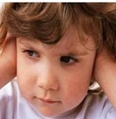 Little girl covering ears from auditory dysfunction