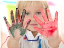 child with tactile dysfunction showing paint on her hands