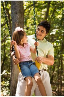 Dad swinging little girl for SPD treatment