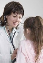 Doctor evaluating a little girl in regards to autism biomedical treatments