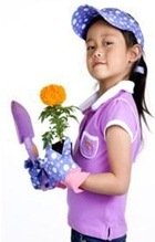 Little girl that is homeschooled due to school behavior problems holding gardening items