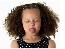 little girl sticking her tongue out and displaying symptoms of defiant children