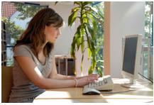A woman on her computer engaged in online business work from home