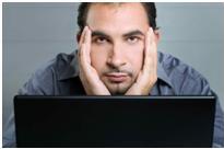 Man looking at computer upset by scam