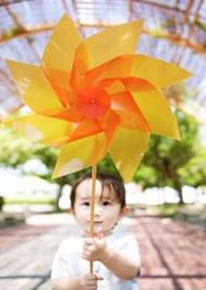 child with sensory disorder playing with pinwheel