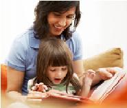 Adult reading child a book during applied behavior analysis therapy